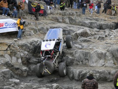 1997 Ford Ranger - A custom off-road buggy navigates a challenging rocky terrain during an event, with spectators watching from above.