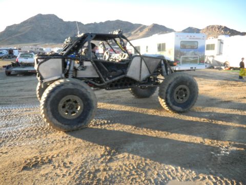 1997 Ford Ranger - This custom off-road buggy is parked in a desert area with RVs and mountains in the background.
