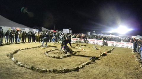 1997 Ford Ranger - Spectators watch a remote control car race event at night, with Traxxas banners in the background.