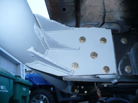 1979 Ford Bronco - Close-up view of a heavy-duty metal bracket attached to a vehicle's frame, likely part of the rear bumper system.