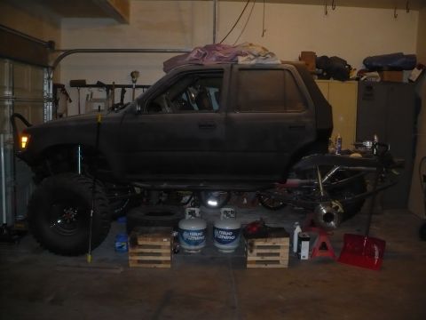 1979 Ford Bronco - SUV is in a garage, appearing to be undergoing significant mechanical modifications.