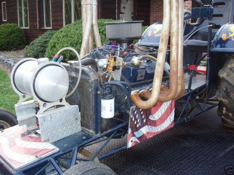 1972 Ford Ranchero - Custom drag vehicle engine bay features dual fuel tanks, large exhaust pipes, and American flag accents.
