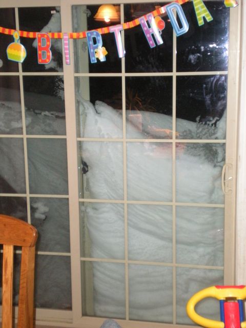1978 Ford Bronco - A large snowdrift blocks a sliding glass door, obscuring the view outside.