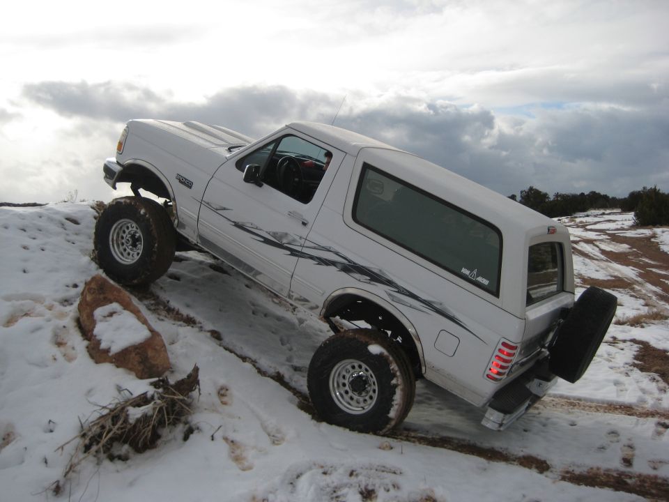 White 1996 Ford Bronco on snowy hill