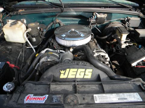 1995 GMC Sierra 1500 - The engine bay of a 1995 GMC Sierra 1500, aftermarket JEGS and Summit Racing Equipment decals.