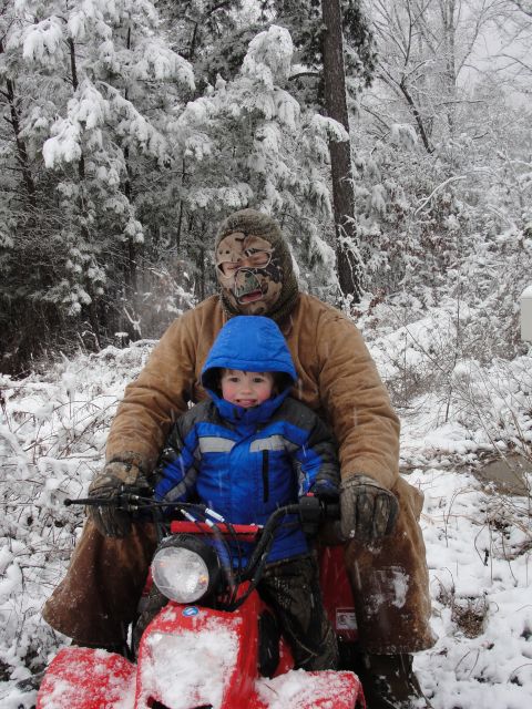 1967 Ford Mustang - Two people ride an ATV through a snow-covered wooded area.