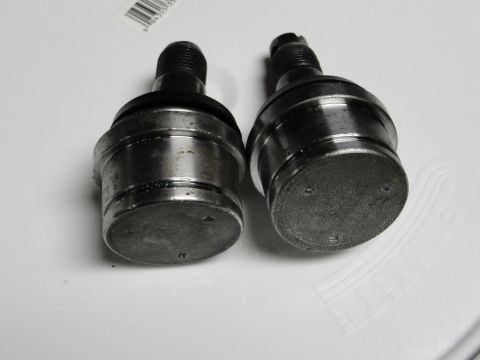 1995 Ford Bronco - Two ball joints, likely for a vehicle's suspension system, are shown in this close-up view.