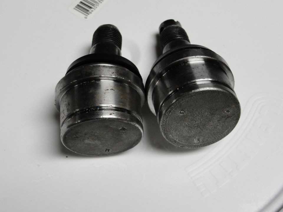 Two metal ball joints with rubber boots