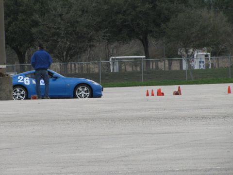 2003 Mazda Protege - A blue sports car with racing numbers is parked on a track next to orange cones.
