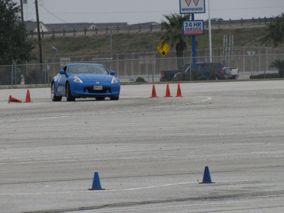 Blue sports car navigating a cone course