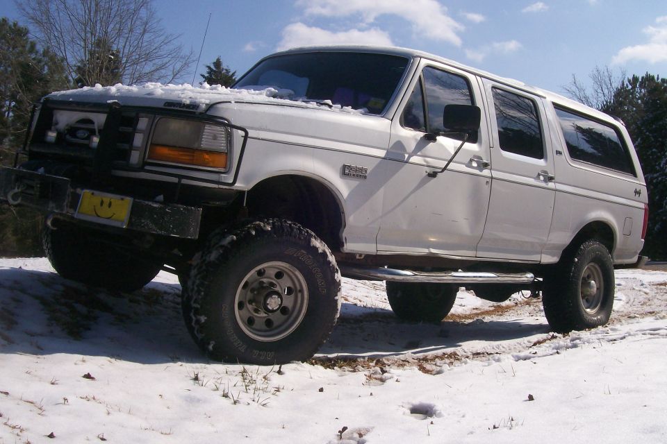 1992 Ford C-350 (Centurion Conversions) parked in snow, front bumper has a smiley face sticker