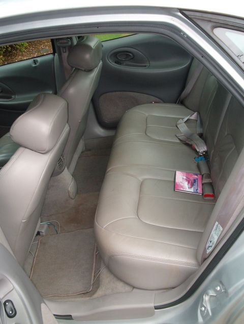 1998 Ford Taurus - The interior of a 1998 Ford Taurus is visible from the rear passenger side.