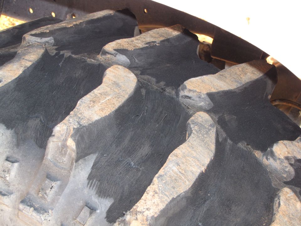 Close-up of a large, aggressive tread pattern on a tractor tire