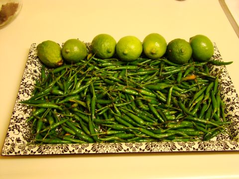 1970 Mercury Cougar - A tray filled with numerous green chilies and several limes sits on a counter.