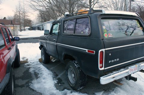 1979 Ford Bronco - Black 1978 Ford Bronco with roof rack and trailer hitch, parked next to a red SUV.
