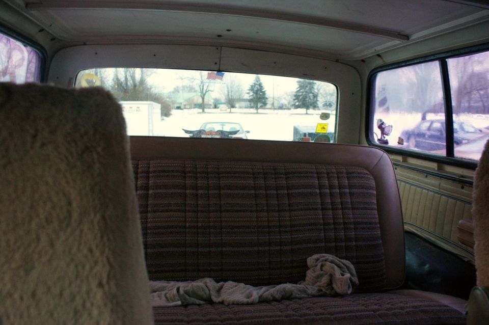 Interior of 1979 Ford Bronco with plaid seats and snowy scene outside