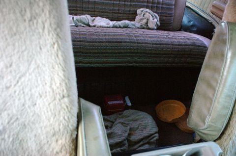 1979 Ford Bronco - Interior view of a vehicle's rear seating area with items on the floor.