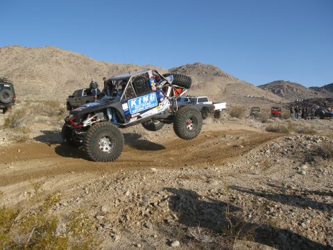 1986 Ford Bronco - A custom off-road buggy takes flight during a desert race event.