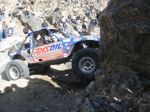 1986 Ford Bronco - A custom-built off-road buggy tackles a challenging rocky course during an event.