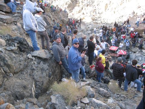 1986 Ford Bronco - Spectators gather on rocky slopes to watch an off-road race event.