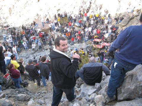 1986 Ford Bronco - A crowd gathers to watch an off-road vehicle navigate a challenging rocky course.