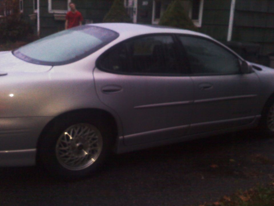 Silver 2000 Pontiac Grand Prix sedan, side view. Frost on rear window