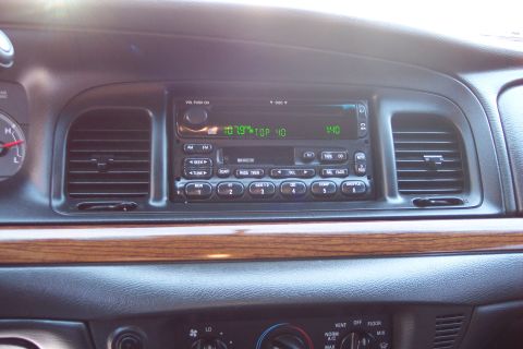 2001 Ford Crown Victoria - Dashboard of a 2001 Ford Crown Victoria, the factory radio and wood trim.