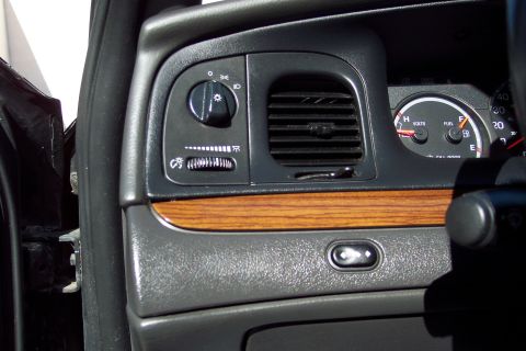 2001 Ford Crown Victoria - Close-up of a vehicle's dashboard, showing the driver's side controls and instrument cluster.