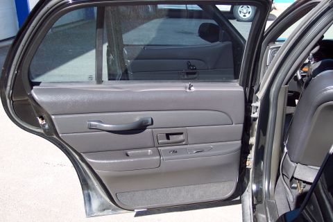 2001 Ford Crown Victoria - Interior view of the rear passenger door panel and window of a 2001 Ford Crown Victoria.