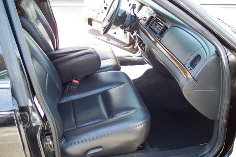 2001 Ford Crown Victoria - Interior view of a black 2001 Ford Crown Victoria, highlighting the leather seats and dashboard details.