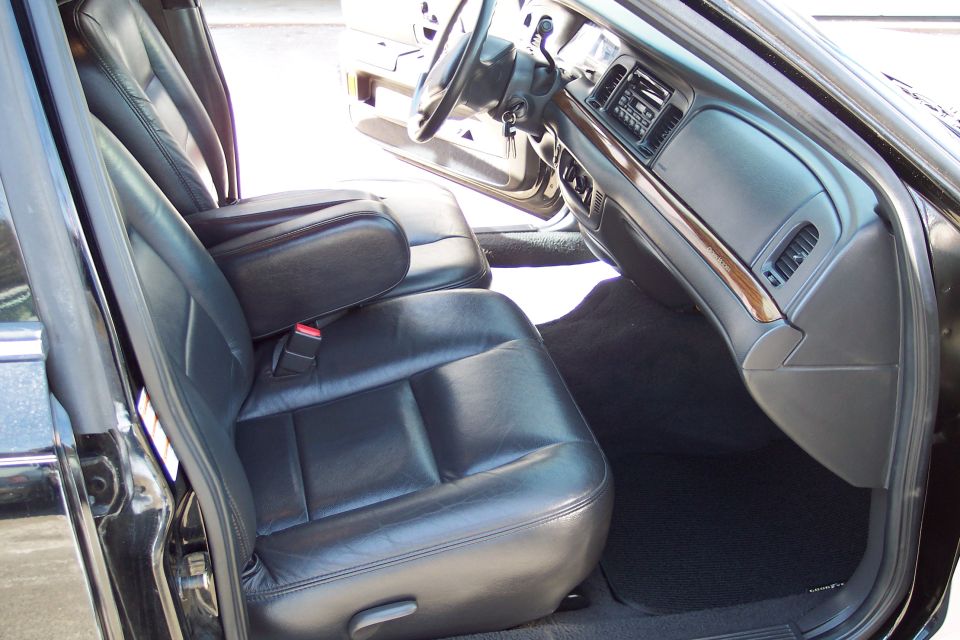 Interior view of black 2001 Ford Crown Victoria showing leather seats and dashboard