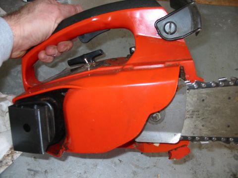 1992 Ford Bronco - Close-up of an orange chainsaw, showing the handle and chain mechanism.