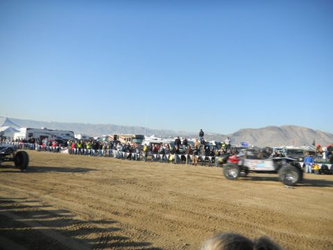 1997 Ford Ranger - Off-road vehicles compete in a race with spectators watching from the sidelines.