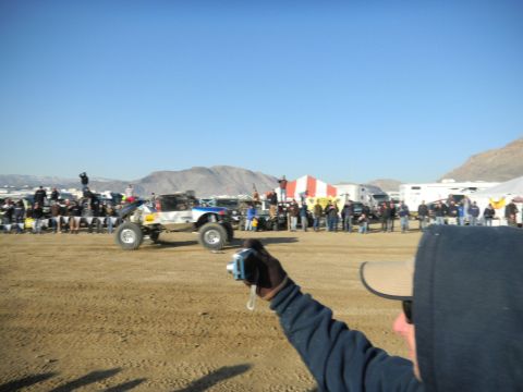 1997 Ford Ranger - A custom off-road truck competes in a desert race event with spectators watching.