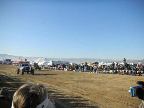 1997 Ford Ranger - Spectators watch off-road vehicles compete in a race event with tents and RVs in the background.