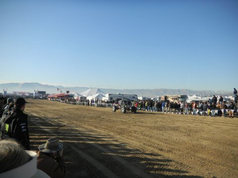 1997 Ford Ranger - A crowd watches an off-road buggy race on a sunny day with mountains in the distance.