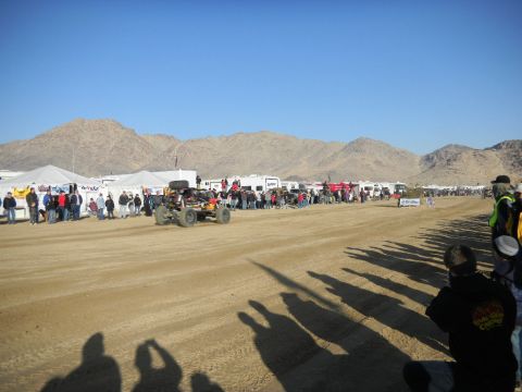 1997 Ford Ranger - A desert race event with spectators and support vehicles gathered under tents.