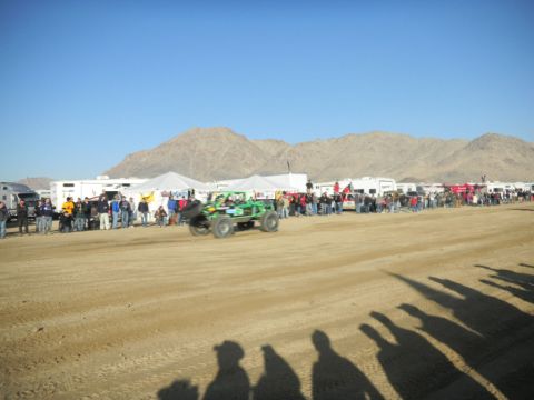 1997 Ford Ranger - A desert race event with spectators gathered around RVs as a buggy speeds by.