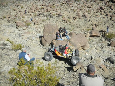 1997 Ford Ranger - A custom off-road buggy sits on a rocky slope, with spectators gathered around.