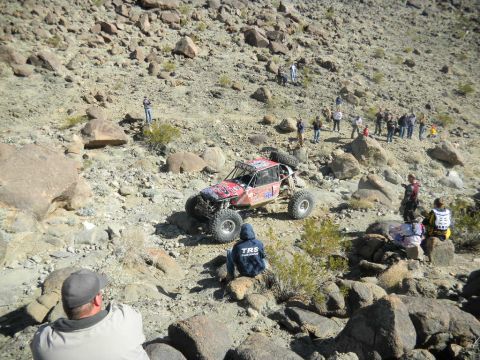 1997 Ford Ranger - A custom-built off-road buggy tackles a challenging rocky course, observed by onlookers.