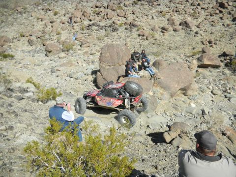 1997 Ford Ranger - Off-road buggy tackles challenging rocky terrain while spectators observe the action.