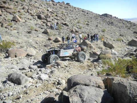 1997 Ford Ranger - A custom off-road buggy tackles a challenging rocky course in a desert landscape.