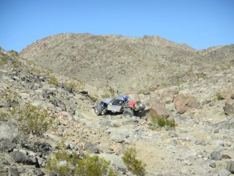 1997 Ford Ranger - A custom off-road buggy traverses a , rocky desert landscape under a clear blue sky.