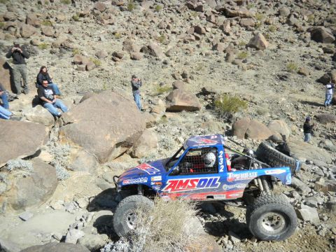 1997 Ford Ranger - This off-road race truck, adorned with AMSOIL branding, navigates a challenging rocky course during a desert race event.