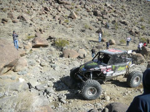 1997 Ford Ranger - A custom off-road buggy tackles a challenging rocky course with spectators watching from the sidelines.