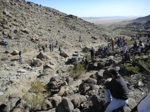 1997 Ford Ranger - Spectators gather to watch off-road vehicles traverse a desert landscape during an event.