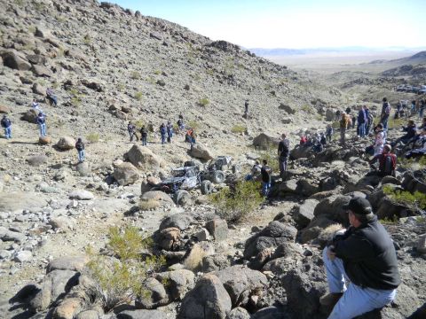 1997 Ford Ranger - Spectators watch off-road vehicles navigate a rocky terrain during an event.