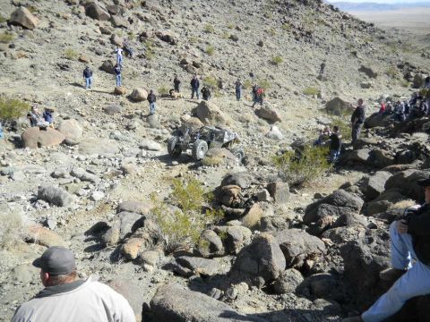 1997 Ford Ranger - A group of people watch an off-road buggy navigate a rocky, desert landscape.