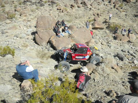1997 Ford Ranger - A custom-built buggy tackles a challenging off-road course with spectators watching.