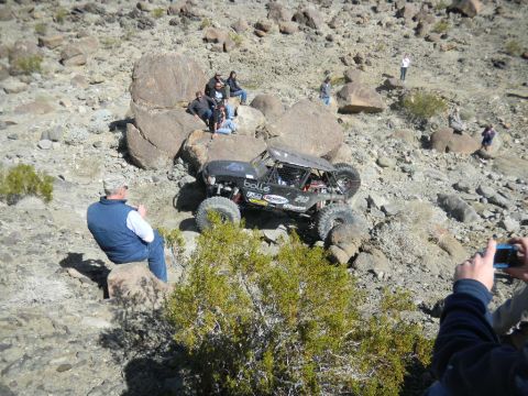 1997 Ford Ranger - A custom off-road buggy navigates a challenging rocky course with onlookers observing the action.